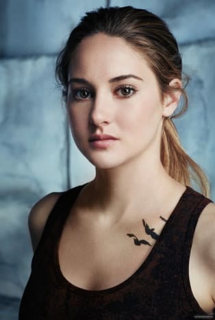 Da Tris slutter sig til den divergerende fraktion, blæk hun kravebenet med tre elegante fugle.